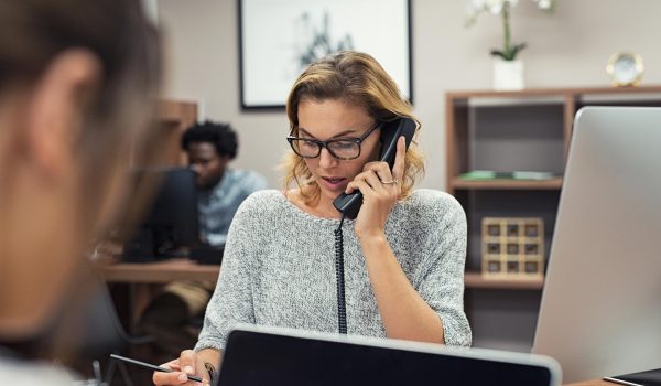 Businesswoman talking on phone at office.